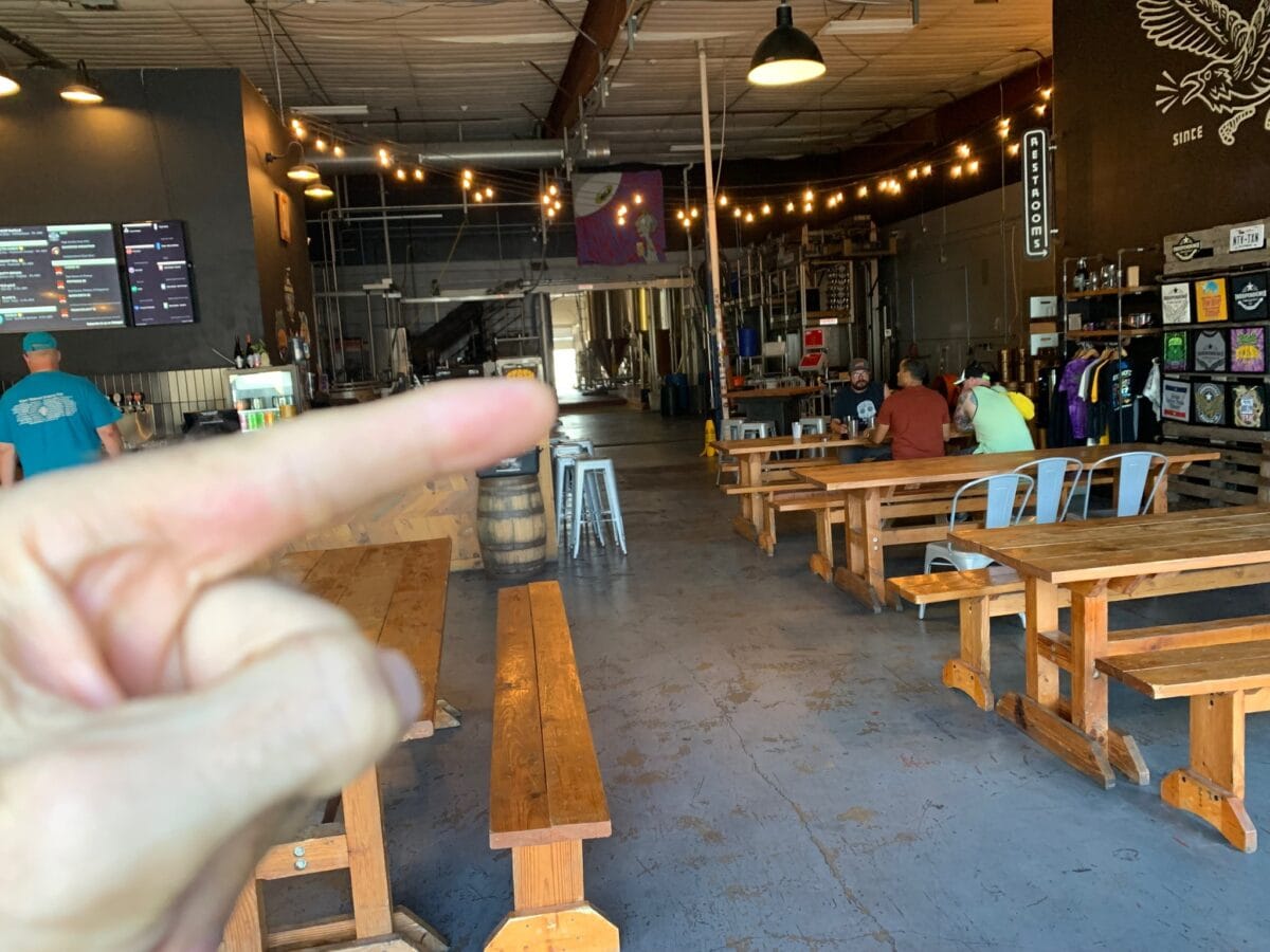 We are setting up on the west side of the Tap Room, from the front bay door to the back area just below the purple and white art you can see hanging from the ceiling.